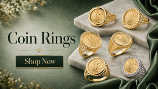 Luxury gold coin rings displayed on marble with deep green accents and a Shop Now button for the Coin Rings collection.